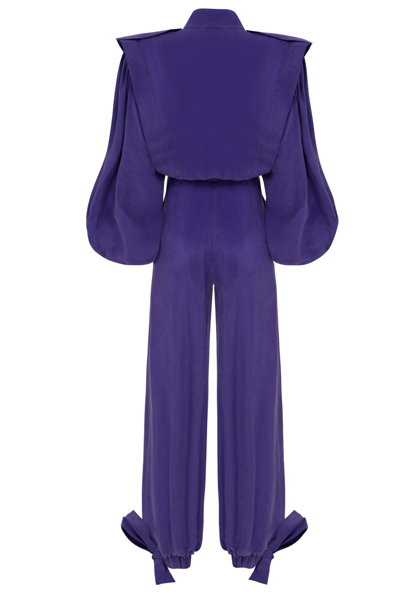 Back view of a purple Haleia jumpsuit with a belt, showcasing its stylish design and fitted silhouette.