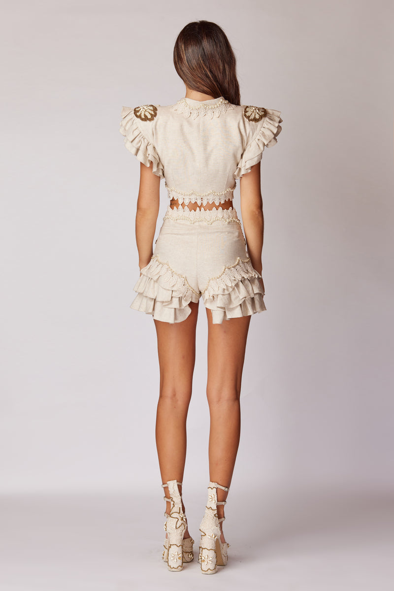 Beige handmade lace detailed ruffled linen jacket by HALEIA, showcasing intricate lace accents and ruffled design on a stylish top.
