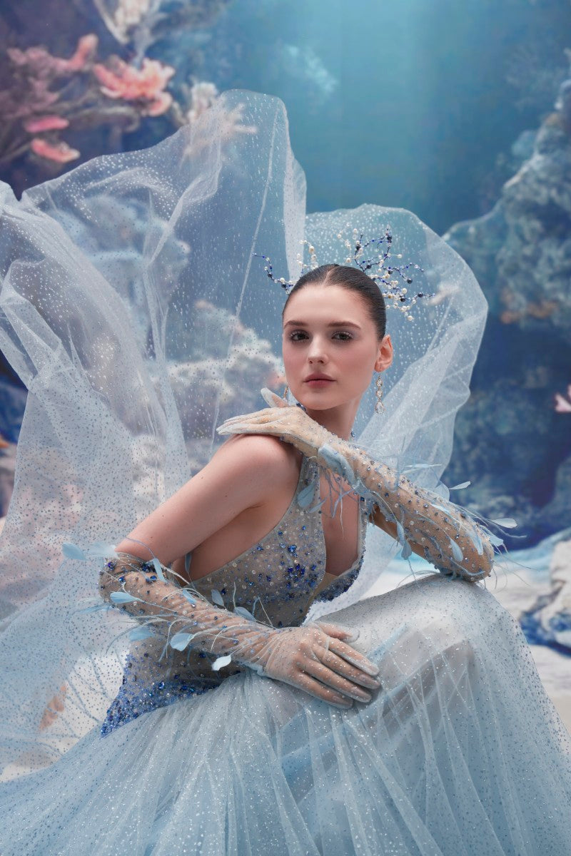 Light blue Muriel glitter tulle gown by 21Six with matching gloves, featuring elegant draping and shimmering fabric.