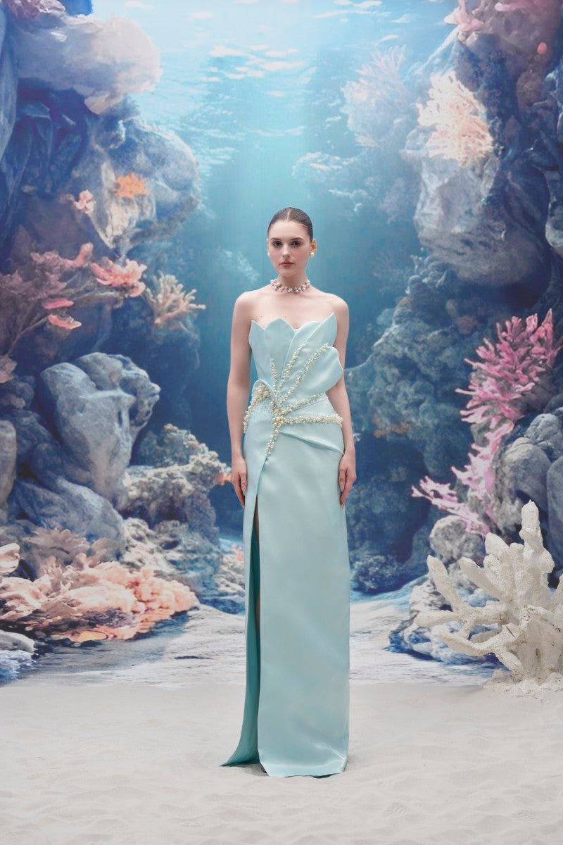 Light blue Sirena water silk taffeta gown by 21Six, flowing floor-length dress with elegant draping and sleeveless design.