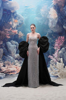 Elegant MOIRAE sequin gown paired with a Marisol taffeta cape from 21Six, showcasing luxurious evening wear with shimmering details.