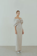 Beige off-shoulder pencil gown by HACCHIC COUTURE, featuring a fitted silhouette and elegant design for formal occasions.