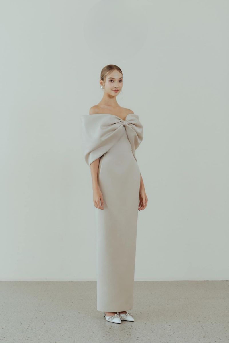 Beige off-shoulder pencil gown by HACCHIC COUTURE, featuring a fitted silhouette and elegant design for formal occasions.