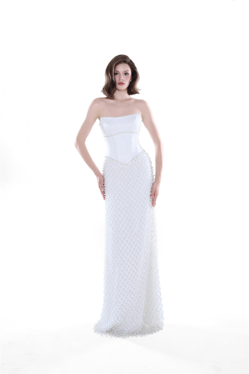 Ivory Camellia Pearl Corset Maxi Dress by HACCHIC COUTURE, featuring a fitted corset bodice and flowing skirt for elegant occasion wear.