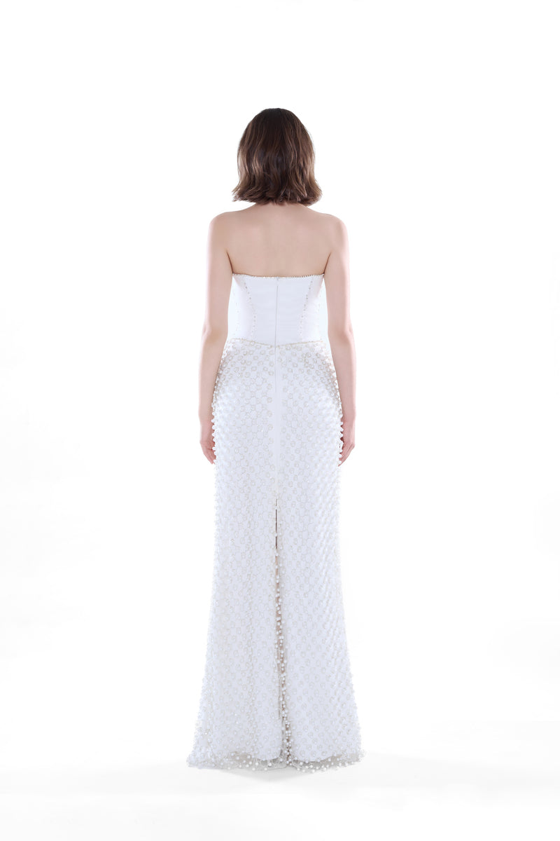 Ivory Camellia Pearl Corset Maxi Dress by HACCHIC COUTURE, featuring elegant pearl embellishments and a flowing silhouette.