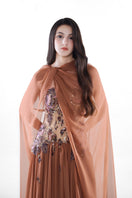 Hacchic Couture Aurora embellished gown in cinnamon rose with intricate embroidery and flowing fabric, elegant evening wear.