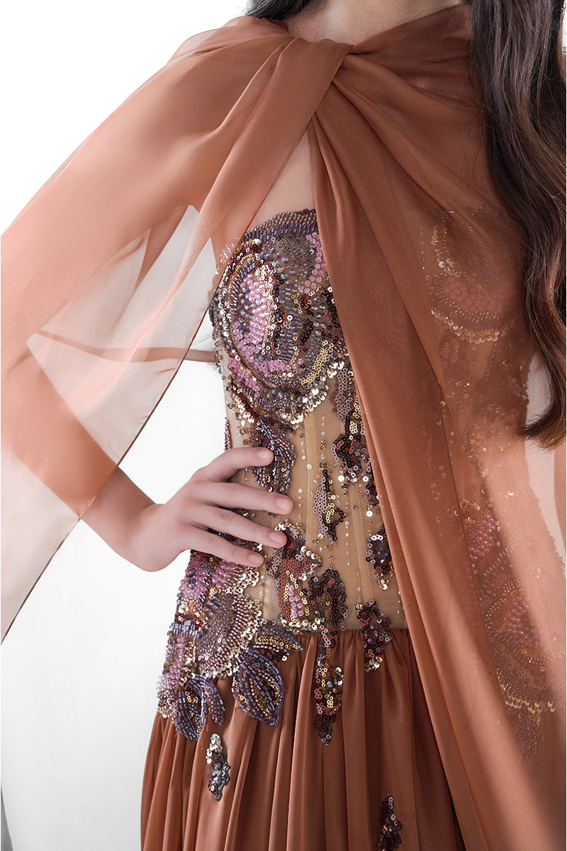 HACCHIC Couture Aurora cape gown in cinnamon rose, elegant maxi dress with flowing fabric and intricate design details.