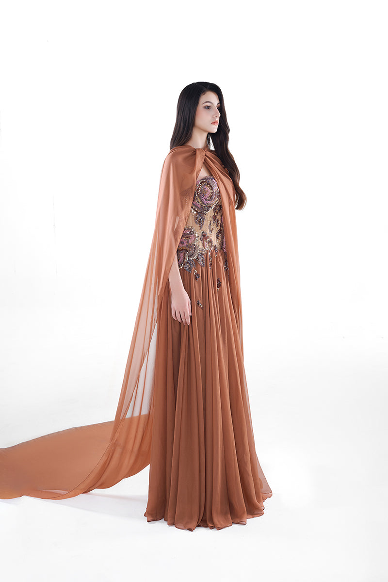 HACCHIC Couture Aurora cape gown in cinnamon rose, a flowing maxi dress with elegant cape detail and soft fabric.