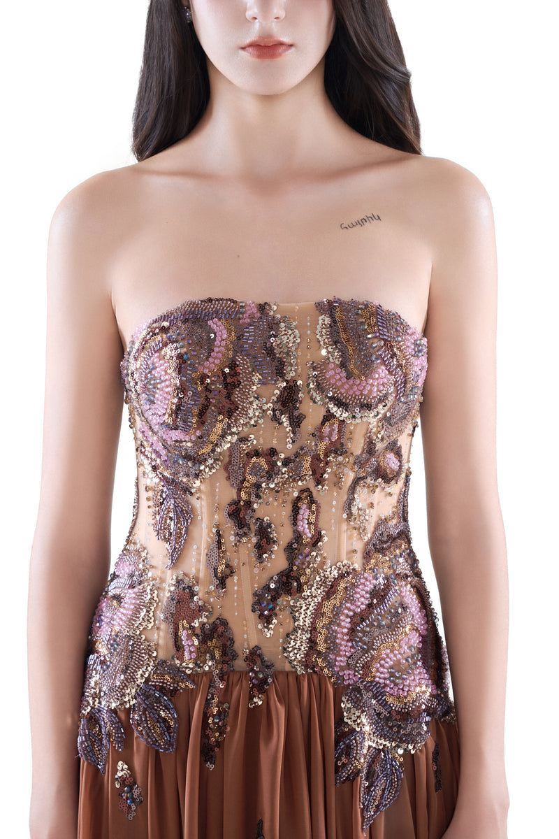Elegant cinnamon rose embellished maxi gown by HACCHIC COUTURE, featuring intricate detailing and flowing fabric.