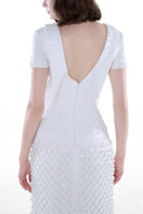 Elegant ivory Camellia Pearl Column Gown by HACCHIC COUTURE, featuring intricate pearl detailing and a sleek, fitted silhouette.