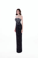 Black and silver Luna Crystal Cape Gown by HACCHIC COUTURE featuring intricate crystal embellishments and flowing elegant fabric.