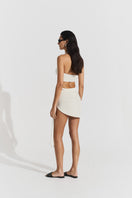 Seaquelle Haven mini skirt in pearl white, a stylish cover-up with a fitted design and smooth fabric, perfect for beachwear.