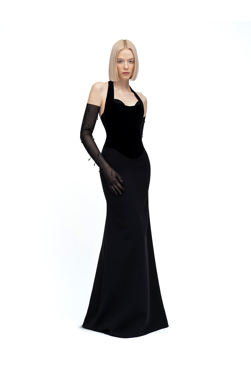 Black HAZAL maxi dress by MOON / HAKAAN YILDIRIM, featuring flowing fabric and elegant design, worn by a model outdoors.