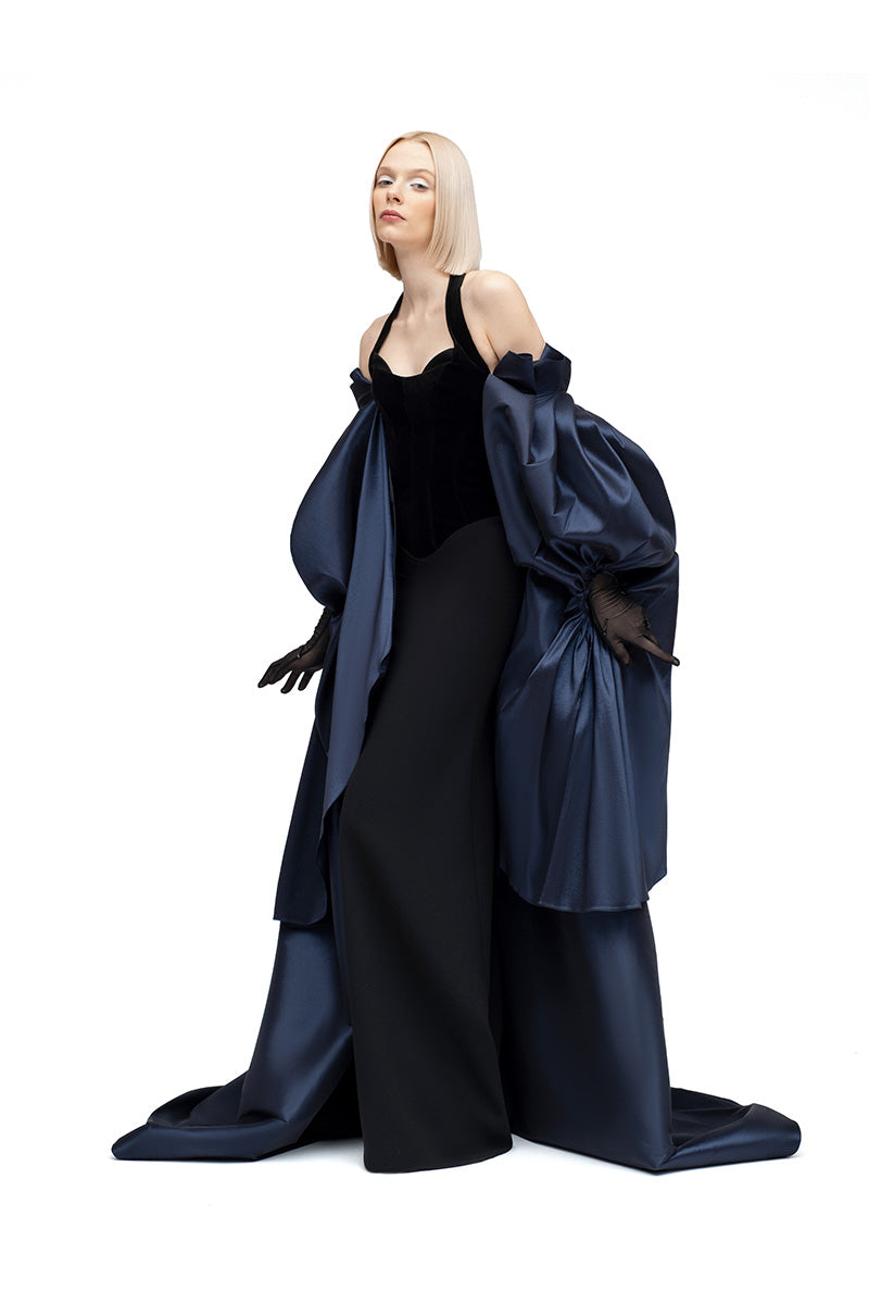 Navy Lotus Cape jacket by Moon Hakaan Yildirim, shown on a hanger with detailed fabric texture and elegant design.
