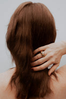 Green heirloom espiral ring by Sara & Flora featuring a unique spiral design and vibrant green gemstone.