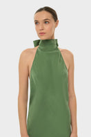 NiLuu AQUAFLORA halter neck moss green slip maxi dress displayed on a model with a flowing silhouette and elegant design.