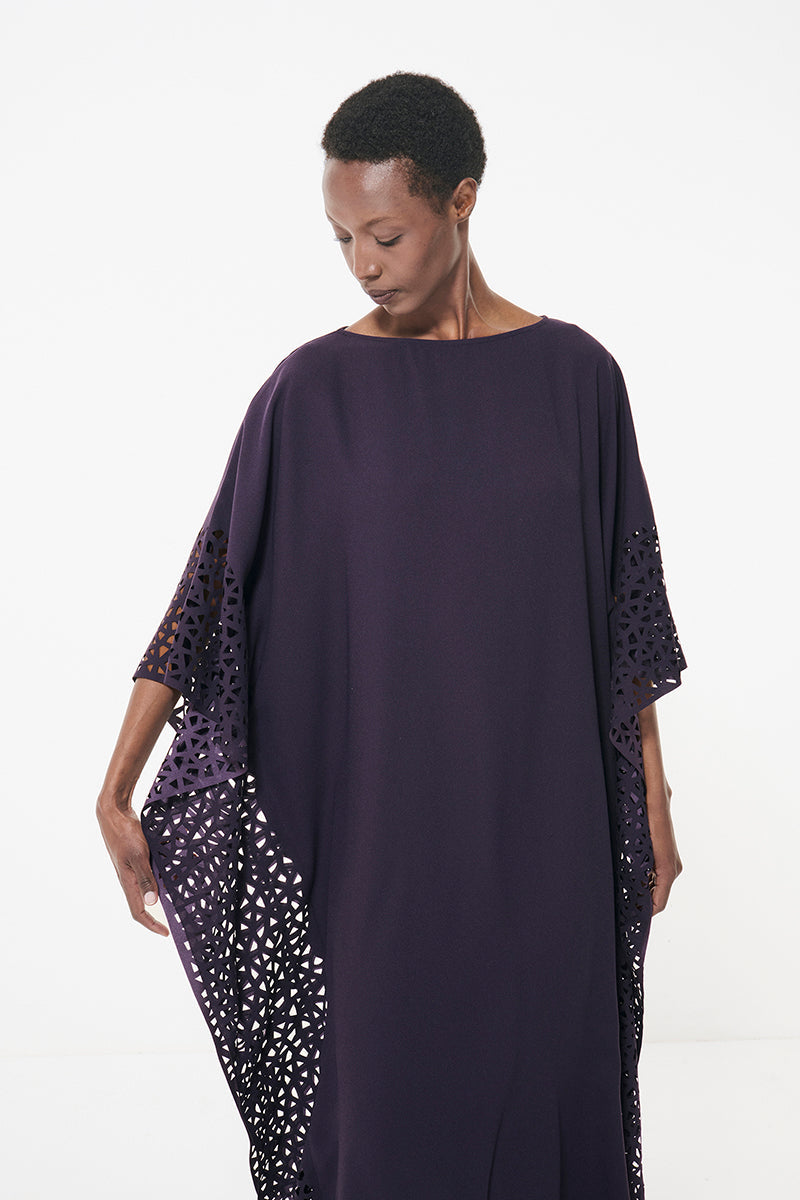 Dark purple laser cut kaftan maxi dress by Leem, featuring intricate laser cut details and flowing fabric.