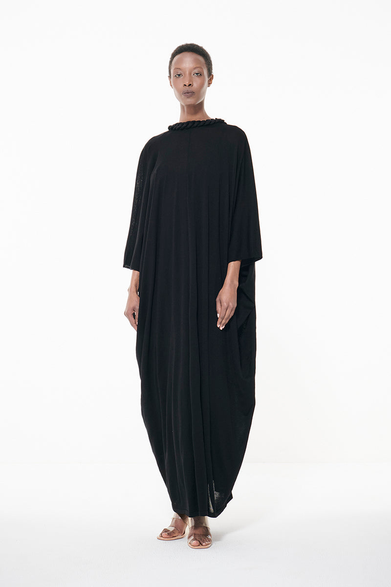 Black Leem maxi dress with knit covered chain detail, featuring a kaftan style and flowing silhouette.