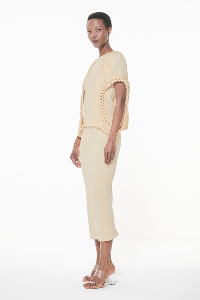 Leem off-white knit pencil maxi skirt displayed on a hanger, showcasing its slim fit and textured fabric.