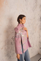 Nadya Shah Hydra Lilac Cape jacket shown on a mannequin, featuring soft lilac fabric and elegant design.