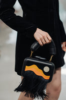 Sy&Vie Habitat Full Moon Clutch with textured surface and sleek design, perfect for stylish evenings.