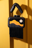Sy&Vie Habitat Full Moon clutch bag with textured design and zipper closure, displayed against a neutral background.