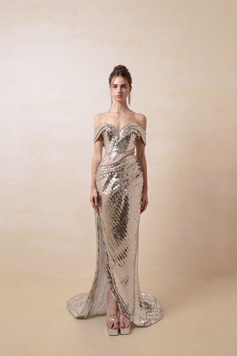 Silver couture gown by HACCHIC COUTURE featuring elegant fabric and intricate design details, perfect for formal occasions.