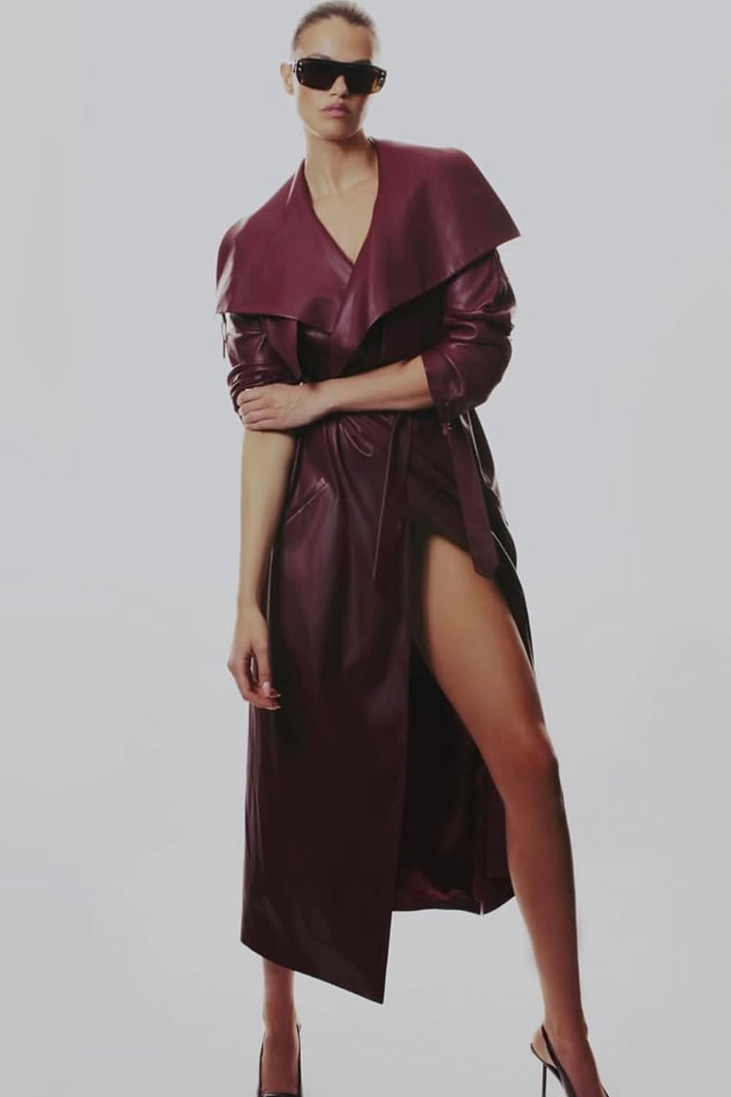 Kris Marán vegan leather maxi trench coat with buckles in burgundy, stylish long coat with belt and buckle details.