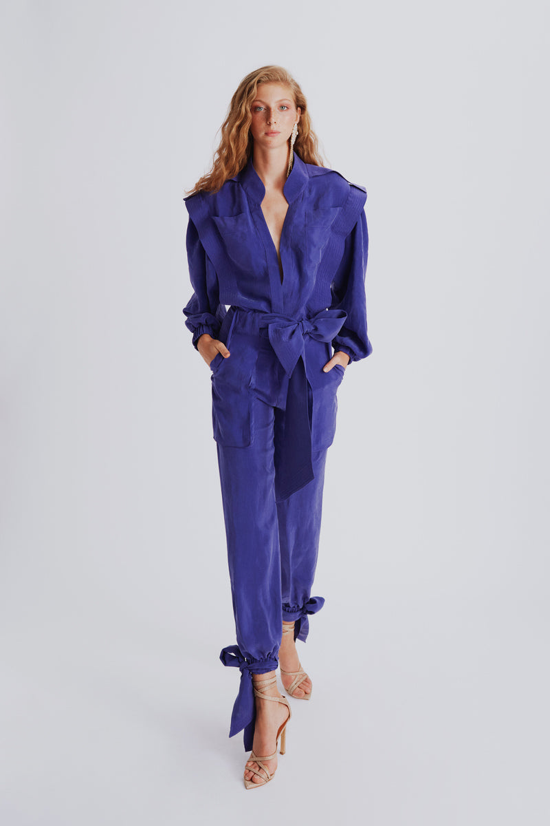 Purple Haleia jumpsuit with a belt, featuring a stylish fit and modern design, perfect for casual or semi-formal wear.
