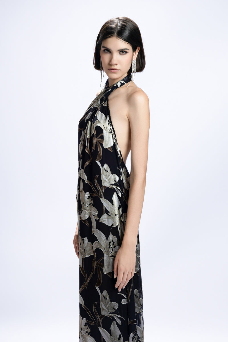 Black Valenciani halter-neck floral printed maxi dress showcased on a model, featuring flowing fabric and elegant design.