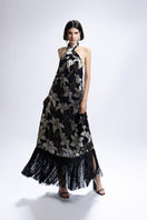 Black Valenciani halter-neck floral printed maxi dress with flowing fabric and a fitted waist, ideal for summer or special occasions.