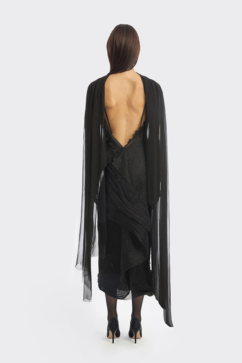 Black twisted pleat midi dress by Stolen Stores featuring hand-pleated fabric and a stylish, elegant silhouette.