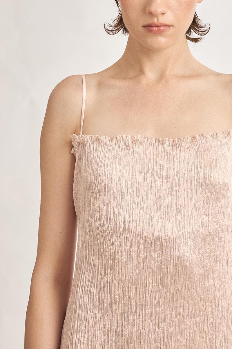 Light pink twisted pleat midi dress by Stolen Stores, featuring hand-pleated fabric and elegant midi length.