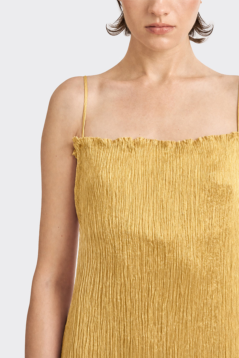 Gold hand-pleated midi dress by Stolen Stores from the CULT MIA X collection, shown on a model.