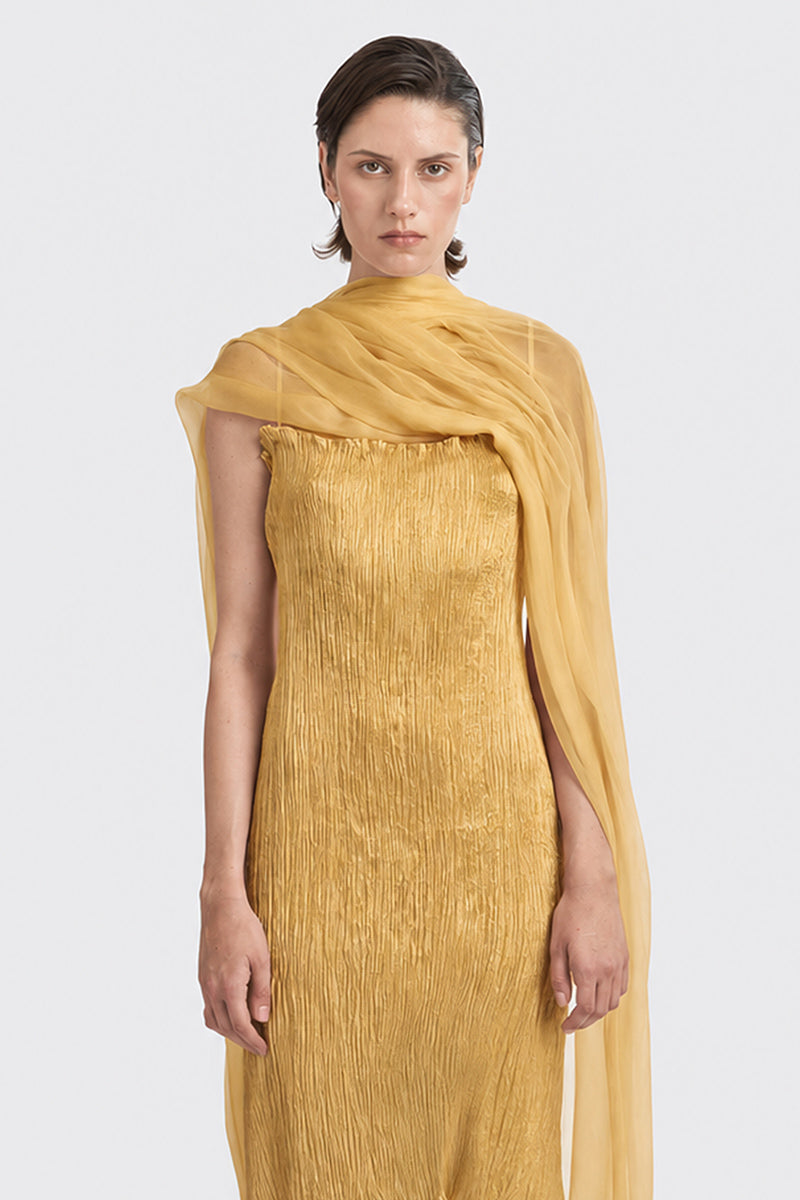 Gold hand-pleated midi dress by Stolen Stores, featuring elegant fabric and stylish design, worn by model on a neutral background.