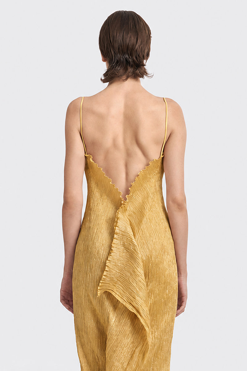 Gold hand-pleated midi dress by Stolen Stores, showcasing flowing fabric and elegant design, worn by a model.