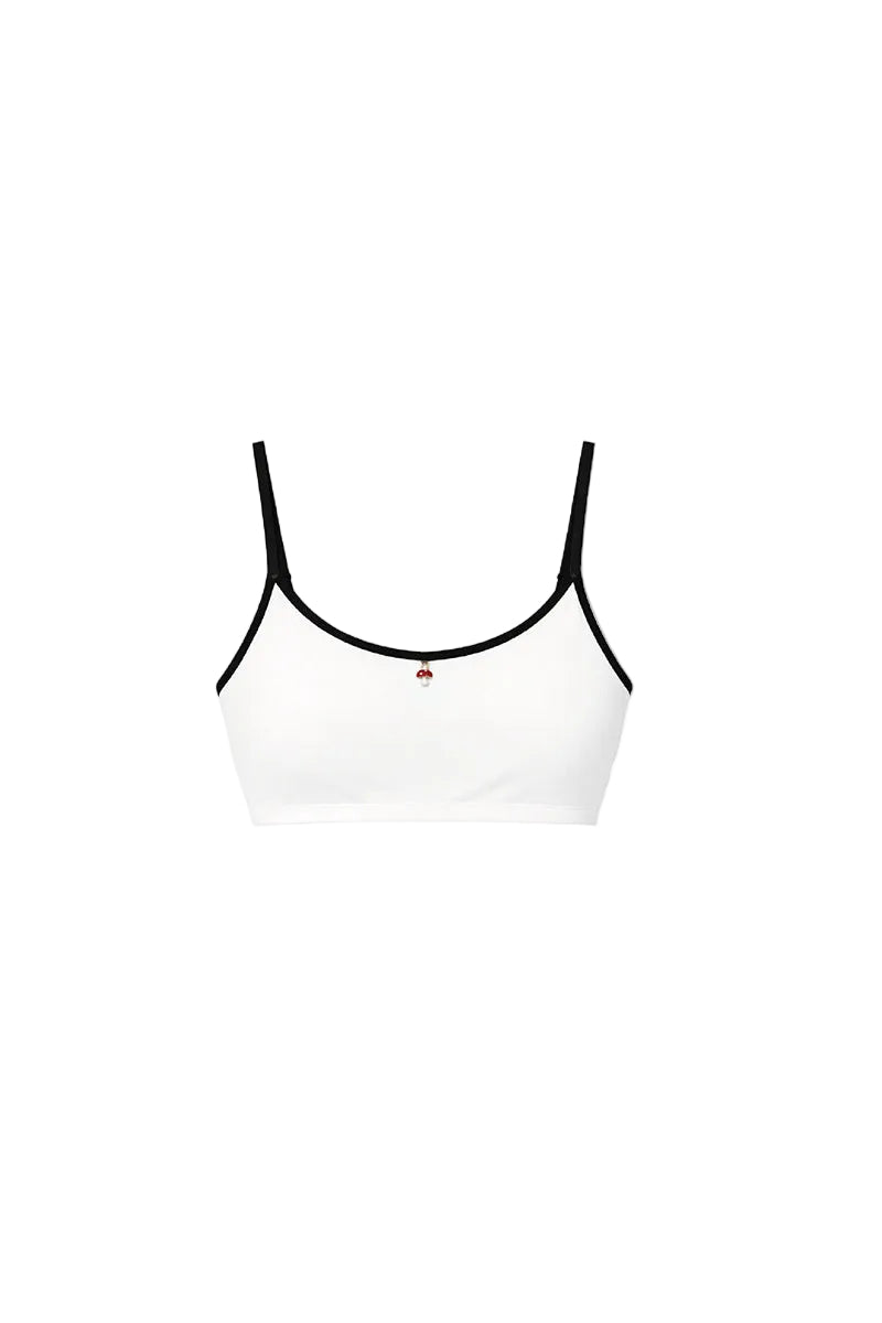 Verdelimon Heaven bikini top in white and black with adjustable straps, front view showing sleek design and contrasting color blocks.