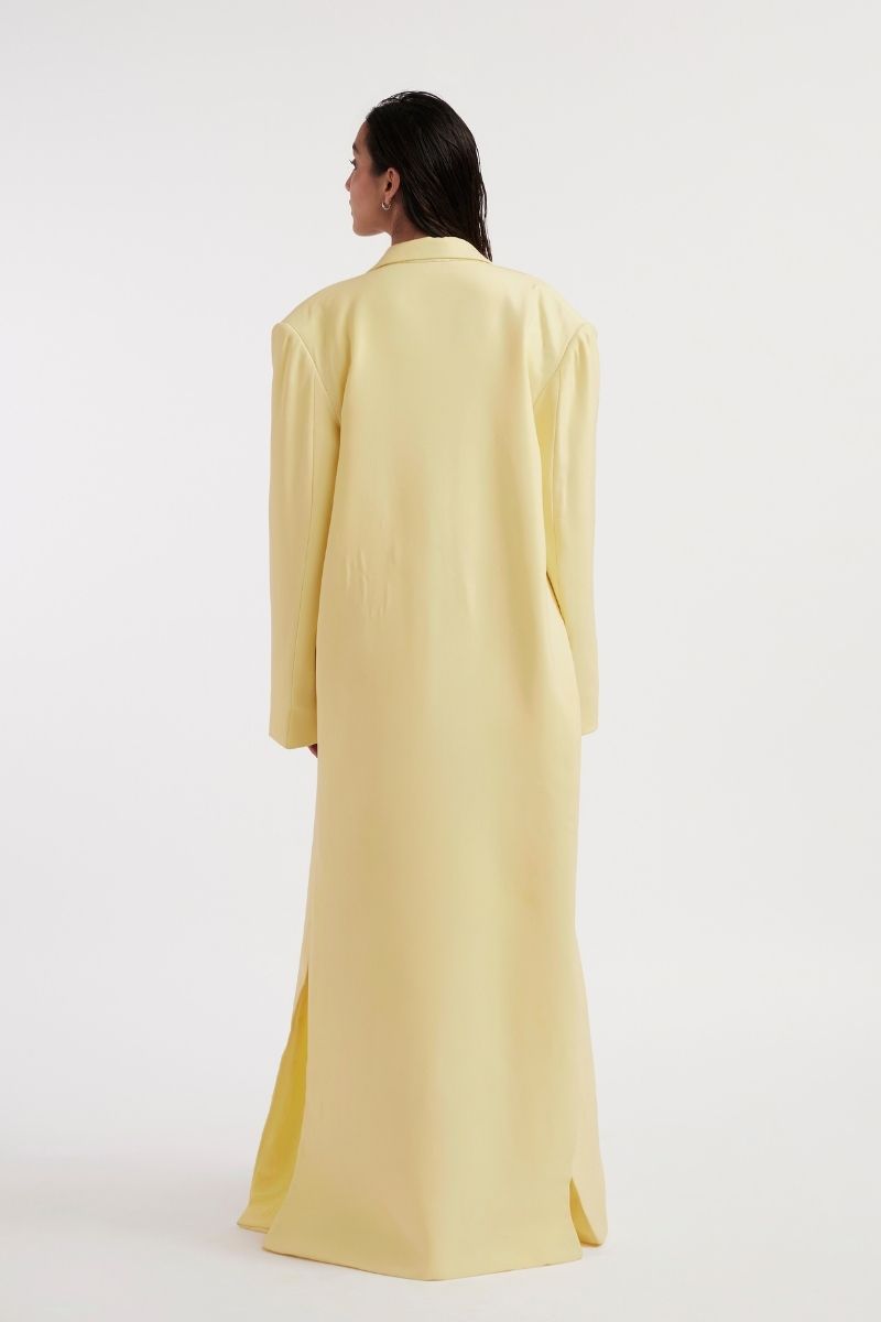 Deme By Gabriella Heloise Butter Yellow Jacket displayed on a hanger, showcasing its vibrant color and stylish design.