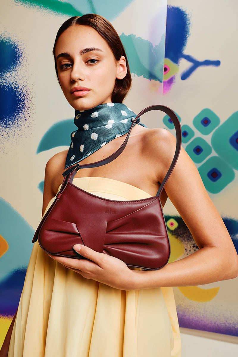 Behno New York Leena mini shoulder bag in brick-colored nappa leather with draped design, stylish and compact for everyday use.