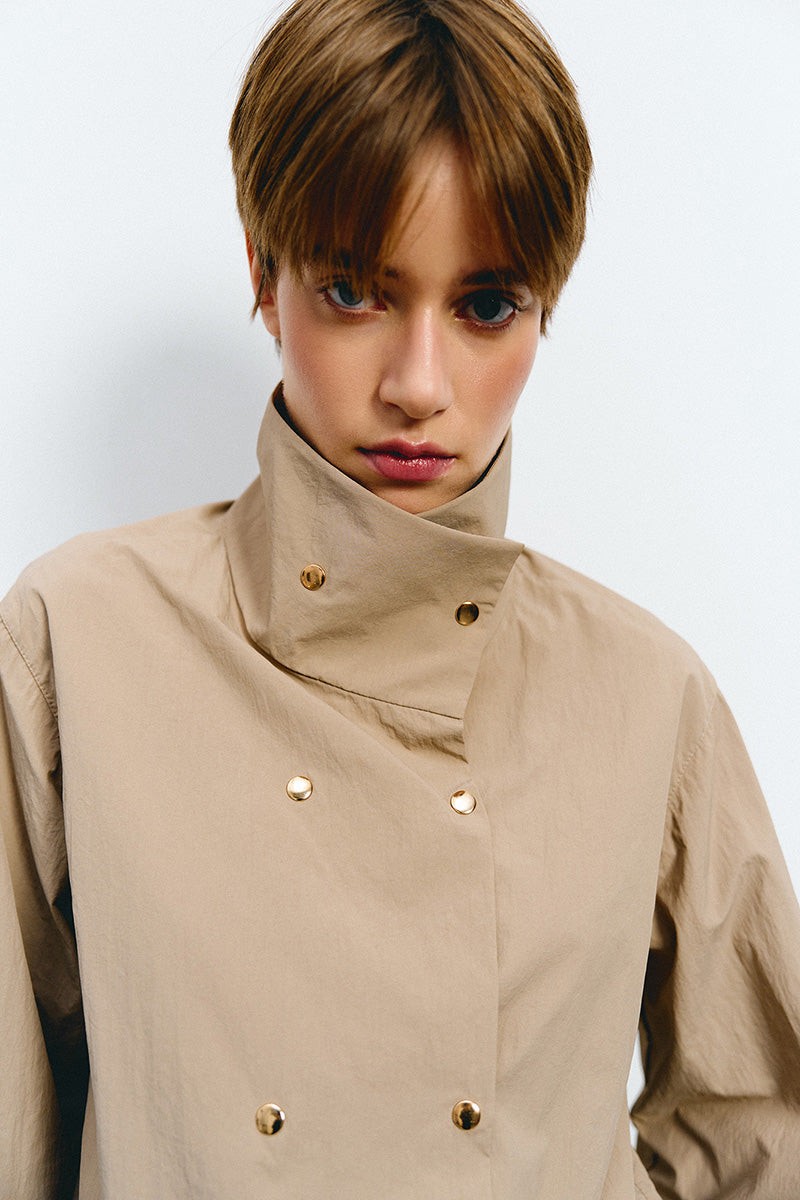 Beige Kris Marán bomber jacket with high neck, stylish outerwear for a modern, casual look.