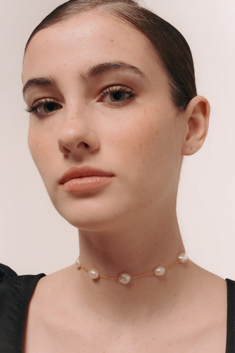 Elegant high priestess pearl choker necklace from LAVANI JEWELS featuring a string of lustrous pearls on a delicate chain.