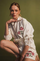 Estefania honey rose blouse, stylish shirt with floral pattern, lightweight fabric, and relaxed fit, displayed on a hanger.