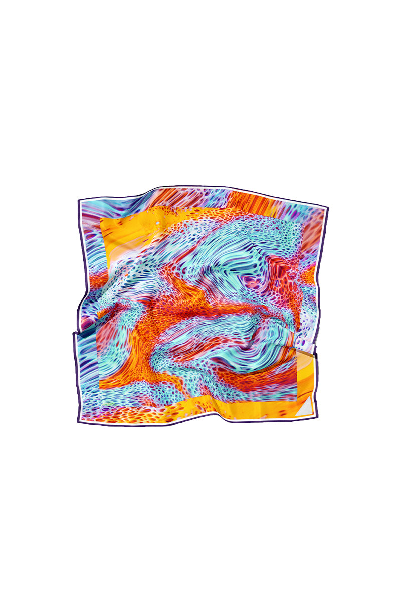 Hot Moussard silk scarf by Amel Batita featuring vibrant patterns and elegant drape, shown in a close-up image.