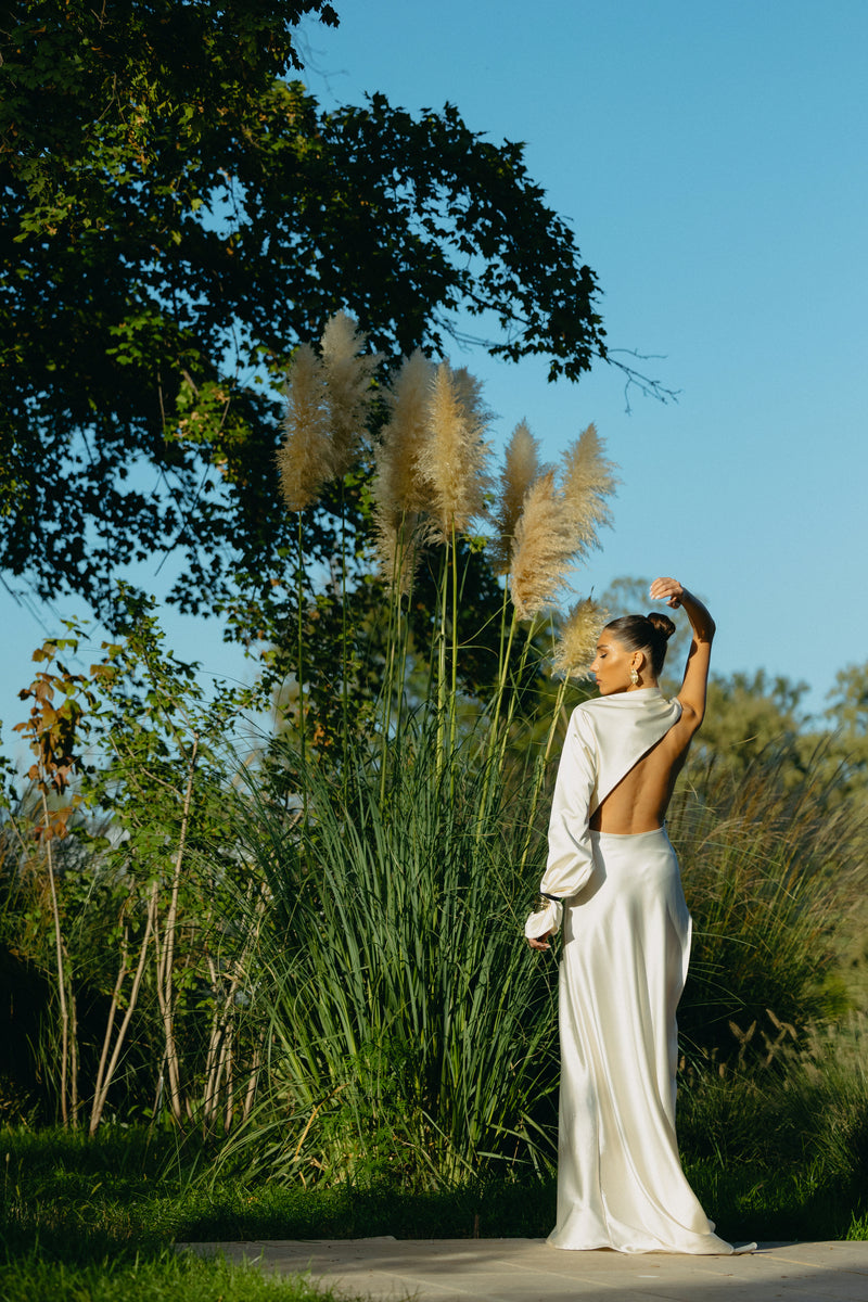 Matters Cannes Pearl Dress gown with elegant pearl embellishments and flowing fabric, showcased on a mannequin.