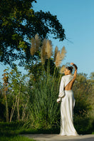 Matters Cannes Pearl Dress gown with elegant pearl embellishments and flowing fabric, showcased on a mannequin.