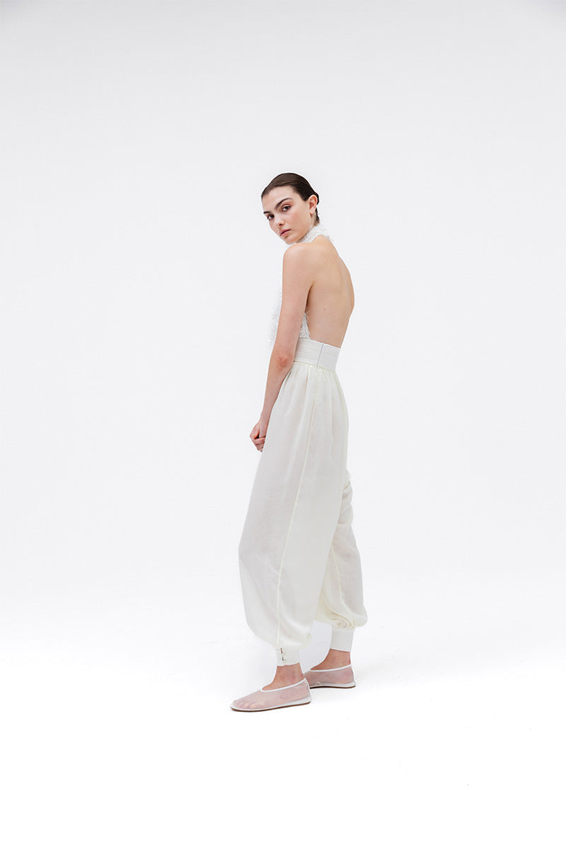 Studio NK Idil Ivory top, stylish sleeveless blouse with a high neckline, made from lightweight fabric, displayed on a hanger.