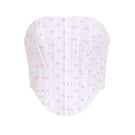 Pink polka dot Candy Top by IKINITA featuring a stylish sleeveless design and playful pattern on a white background.
