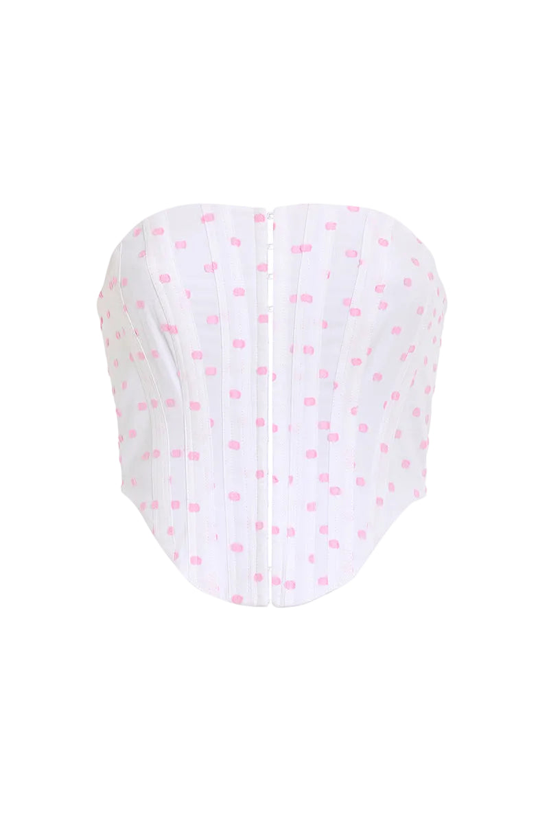 Pink polka dot Candy Top by IKINITA featuring a stylish sleeveless design and playful pattern on a white background.