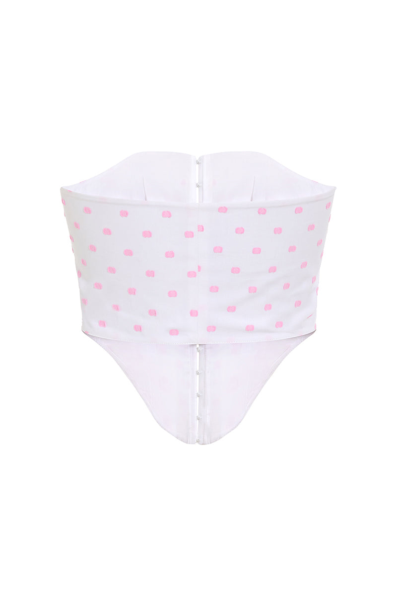 Pink polka dot candy top by IKINITA, featuring a playful design and white background, perfect for casual or stylish outfits.