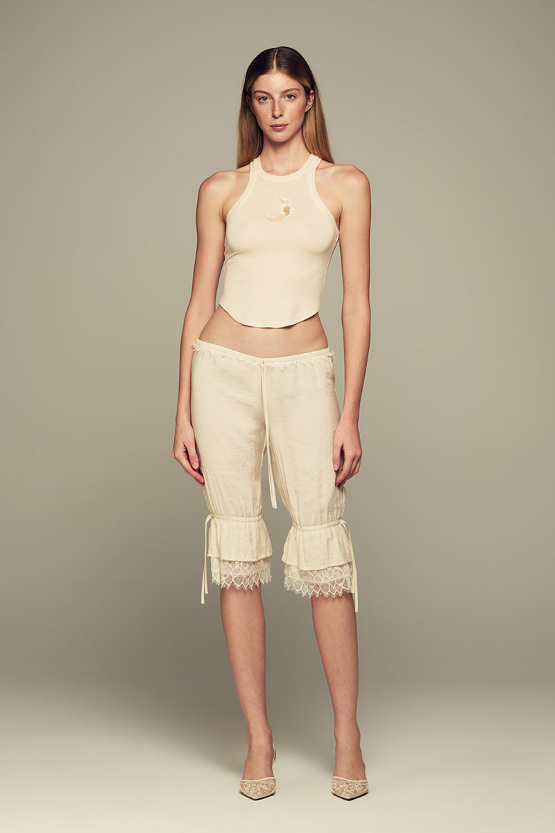 IKINITA Wave Top in Sand, stylish sleeveless blouse with wave details, lightweight fabric, perfect for casual or beachwear.